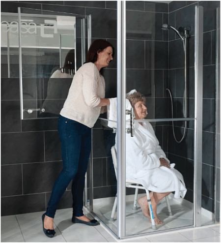 Shower enclosures that facilitate carer assistance.