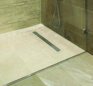 Linear drainage gully installed in a wet room shower floor.