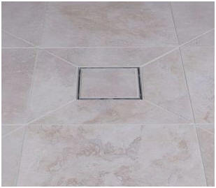 Square gully in tiled floor with tiled gully cover.